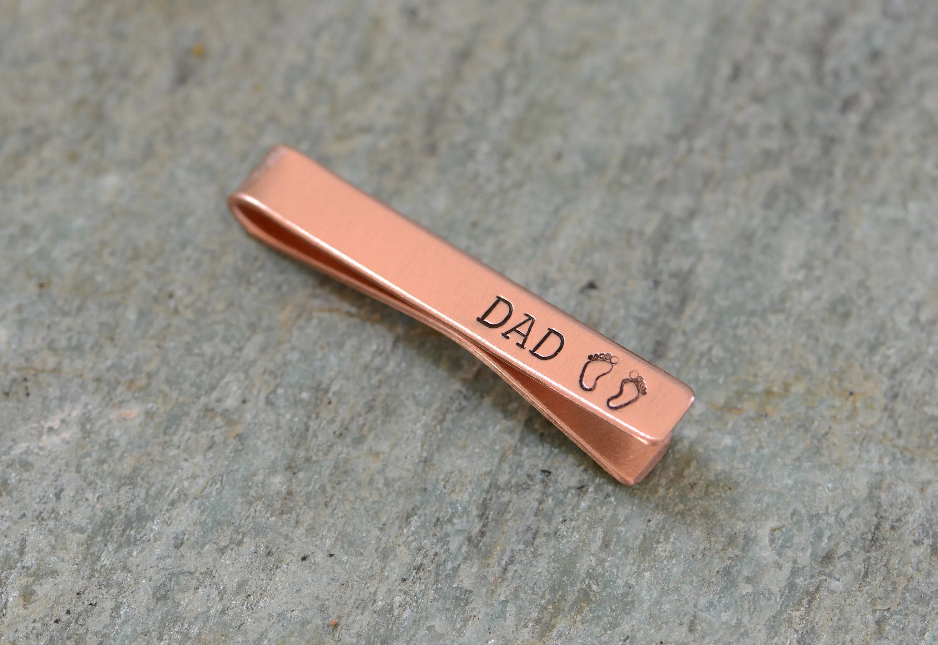 Copper tie clip for new dad stamped with DAD and baby feet